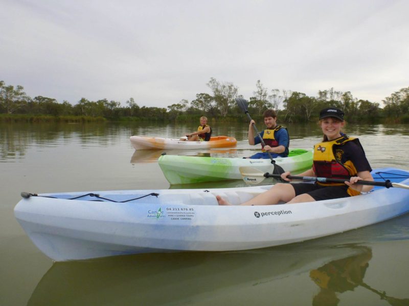 3 youth in sit-on-top kayaks